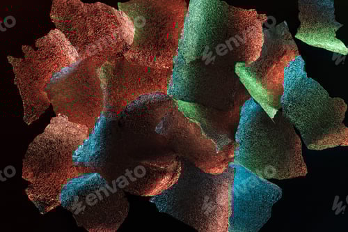 Preview: abstract background of silver textured foil pieces with colorful illumination isolated on black