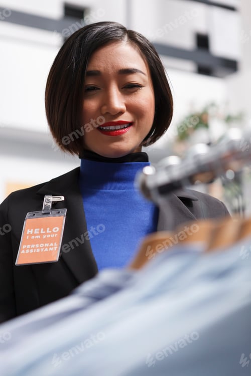 Preview: Butique seller examining formal shirts