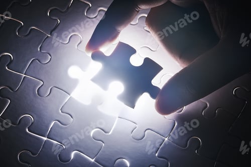 Preview: The last piece to place. Conceptual shot of a persons hand building a puzzle.