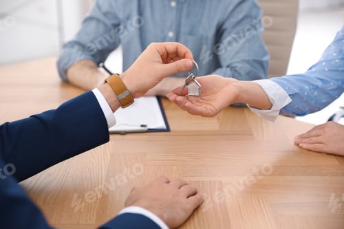 Preview: Real estate agent working with clients in office, closeup