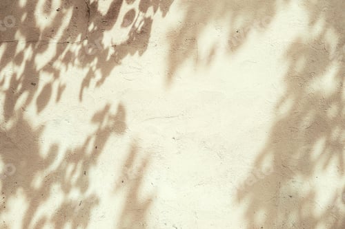 Preview: Tree shadows on beige concrete rough textured background. Dark silhouette of leaves in sunlight