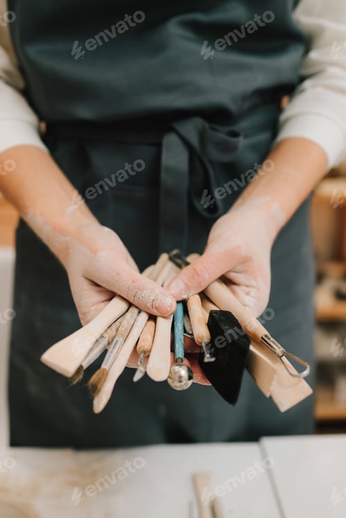 Preview: Potter handles clay sculpting tools. Wooden implements for molding ceramic tableware