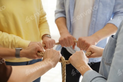 Preview: Unity concept. People holding rope together indoors, closeup