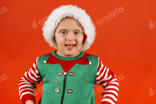 Preview: Happy child with Down syndrome having fun and laughing in studio.