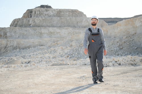 Preview: Worker in hardhat standing in stone quarry