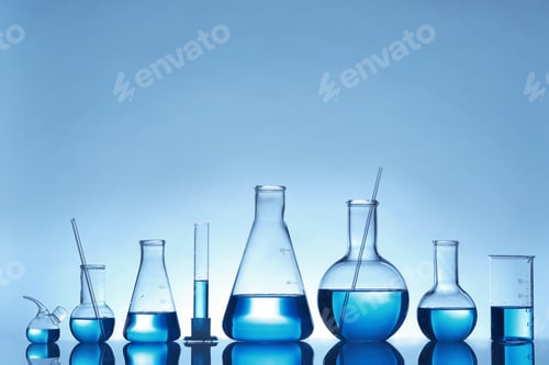 Preview: Laboratory glassware with liquid on table against color background. Chemical analysis