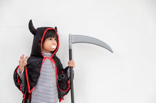 Preview: Children girl wearing mysterious Halloween dress holding a sickle on white background