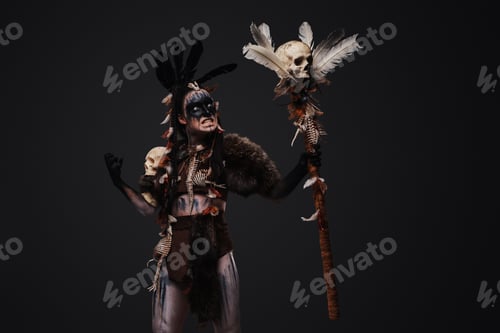 Preview: Painted evil witch with staff against grey background