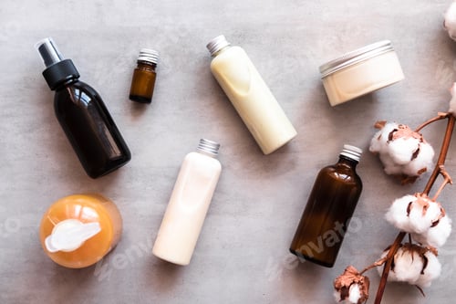 Preview: Bottles with spa cosmetic products from above on gray concrete table