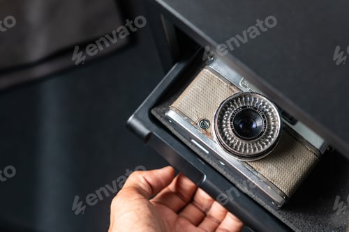 Preview: Hand Pulling Camera Storage Drawer with Vintage and SLR Cameras