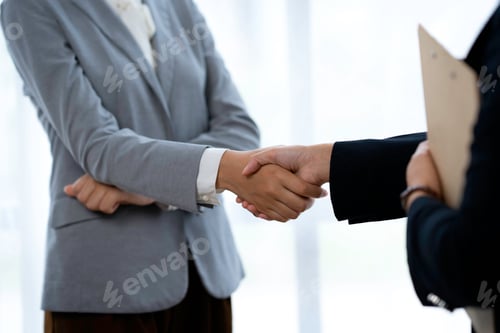 Preview: Business people shaking hands after joining a good business dealing in the office. Collaborative tea