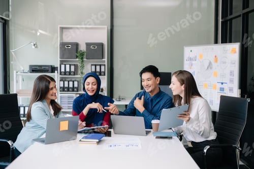 Preview: Happy businesspeople while collaborating on a new project in an office. Group of diverse