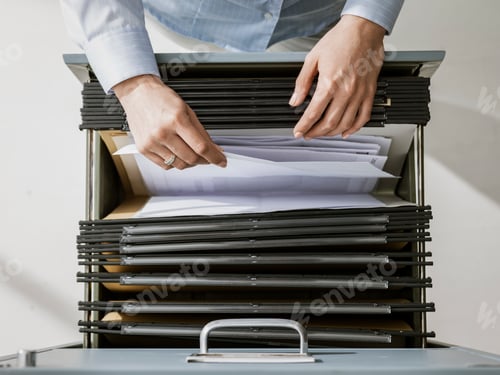 Preview: Office worker searching files in the archive