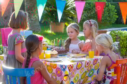 Preview: Girl with friends at table with birthday cake