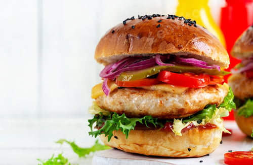 Preview: Sandwich with chicken burger, tomatoes, cheese, pickled cucumber and lettuce. Cheeseburger.