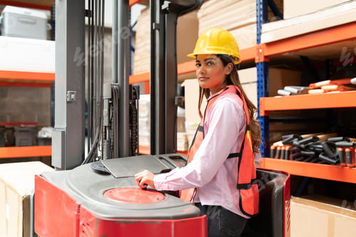 Preview: Female Supervisor Making Eye Contact While Using Machinery