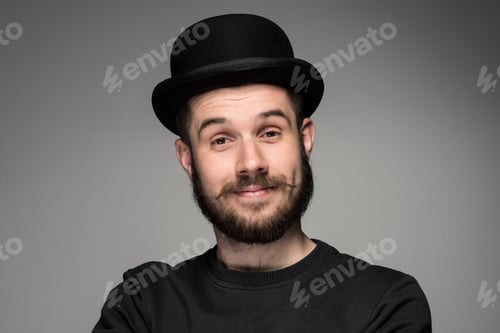 Preview: Closeup Portrait Of Handsome Young Smiling Man In Black Hat On Gray Background. Positive Human