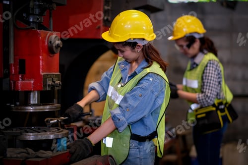 Preview: Pretty woman workers or technician are working with machine in factory.