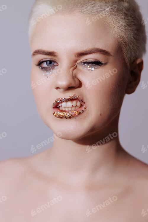 Preview: Portrait of a beautiful woman with short hair with glitter on her lips