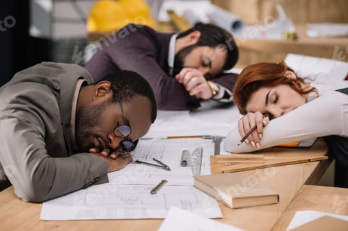 Preview: multiethnic overworked team of architects sleeping at office