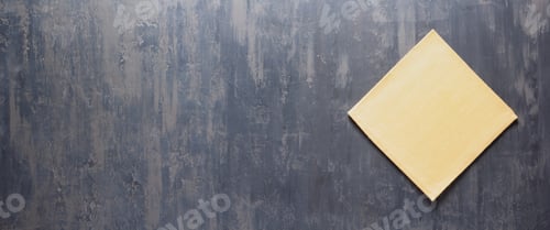 Preview: Folded tablecloth at stone surface of table. Panorama of cloth napkin texture background