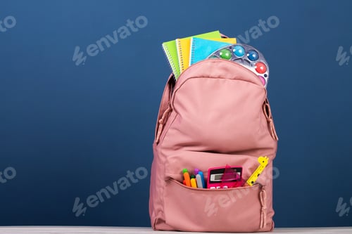 Preview: Backpack with different colorful stationery on table. Back to school