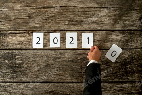 Preview: Male hand changing 2020 sign into 2021 assembled with white cards