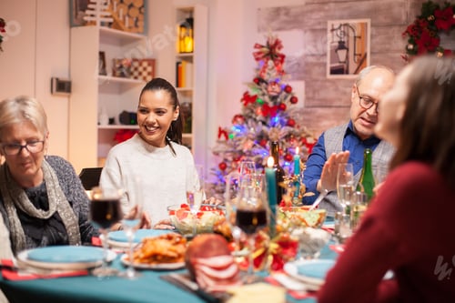 Preview: Happy woman with a big smile at christmas family dinner
