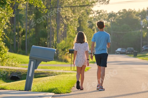 Preview: Back view of two young teenage children, girl and boy