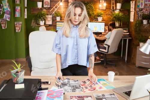 Preview: Creative female dressmaker working in a modern office