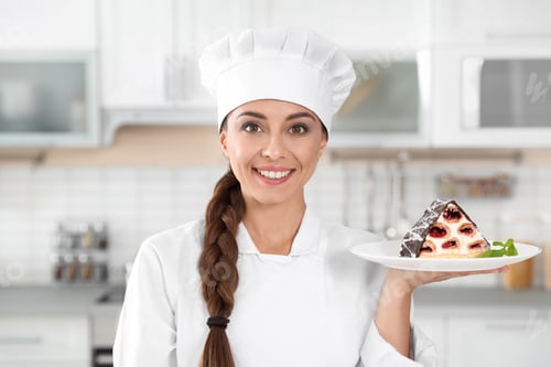 Preview: Professional female chef with plate of delicious dessert in kitchen