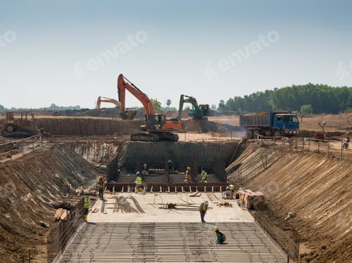 Preview: Close shot of heavy machines and construction workers working on a building