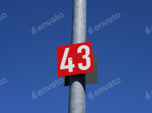 Preview: Number 43 on a red poster on the metal pole