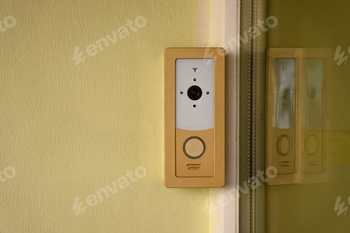 Preview: close up view of intercom on yellow building facade
