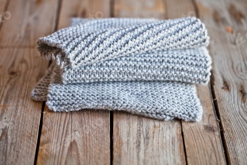 Preview: Soft Knitted Cloth Stacked on Wooden Table