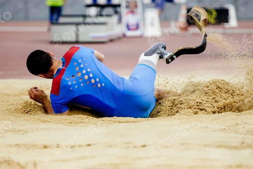 Preview: long jump landing in sand disabled athlete