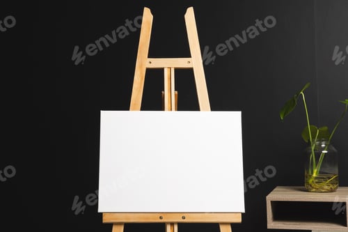 Visualização: White canvas on wooden easel and copy space with desk and plant on black background