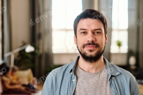 Preview: Happy young man in casualwear looking at you
