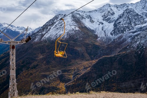 Preview: Mountain landscape with a moving chair of a single-seat cable car