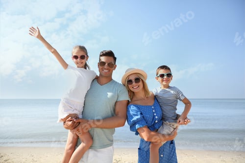 Preview: Happy family at beach on sunny summer day