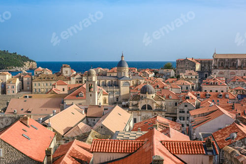 Preview: view of Dubrovnik's old town rooftops with the Adriatic Sea and church in the background in Croatia