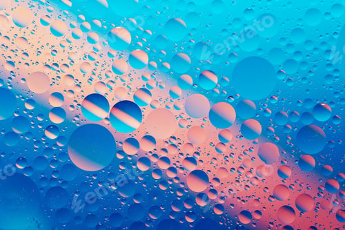 Preview: oil with bubbles on vibrant blue and pink background. Abstract background.