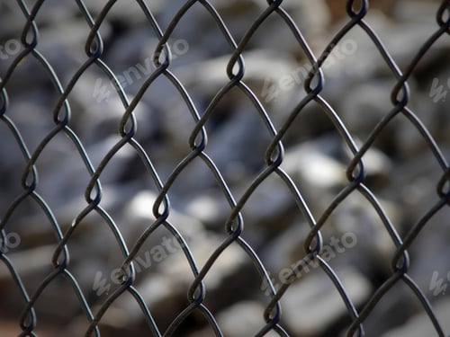 Preview: Chain Link Fence With Rock Background - Close Up Photograph Of A Chain Link Fence With A Blurred