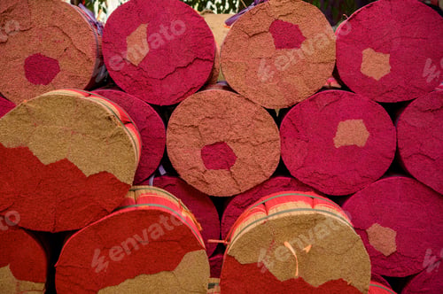 Preview: Rolls of colorful incense sticks tied with ribbons placed on each other in rows in manufacture