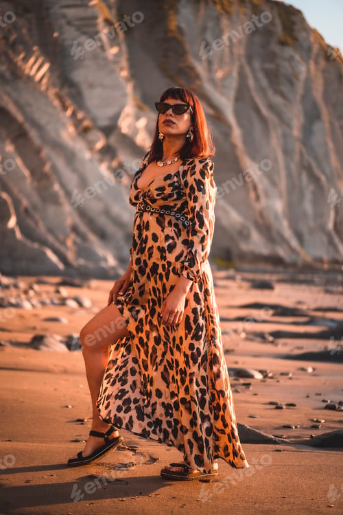 Preview: Summer street style on a beach next to rocks of a young brunette caucasian woman