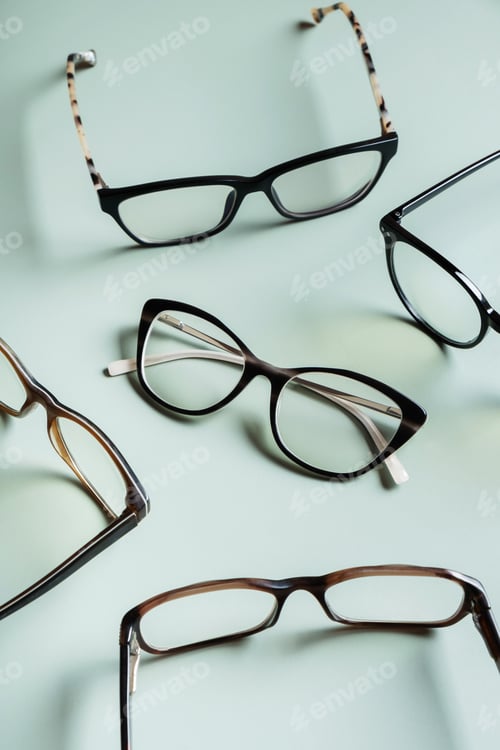 Preview: Stylish eyeglasses on colored background. Optical store, vision test, stylish glasses concept.