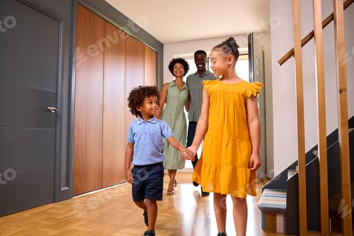 Preview: Family Coming Home After Day Out Opening Front Door And Walking Into Hallway