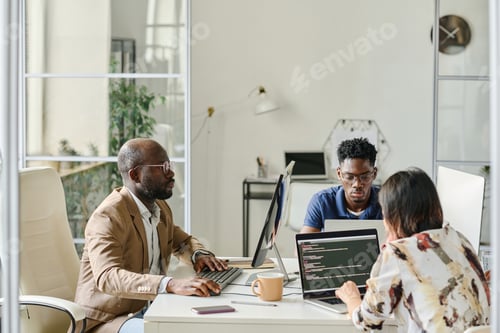 Preview: Programmers working in team on computers