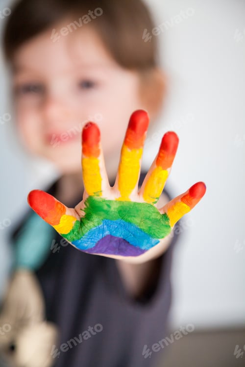 Preview: Little girl showing her hand painted as a rainbow