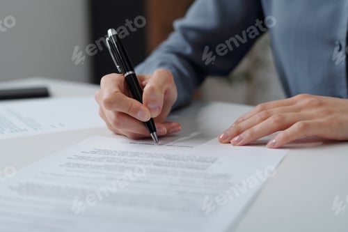 Preview: Woman Signing Contract in Office